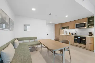 a living room with a table and a kitchen at On 46th Floor! Amazing Views and Free Parking in Miami
