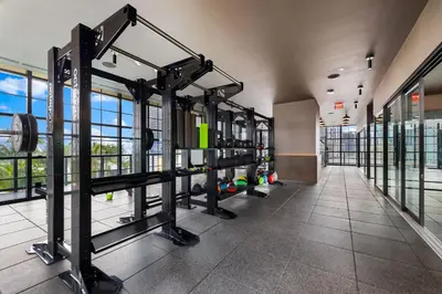 a gym with rows of equipment in a building at On 46th Floor! Amazing Views and Free Parking in Miami