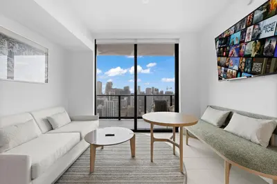 a living room with a couch and a table at Stunning Condo with Free Parking on 46th Floor! in Miami