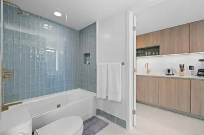 a bathroom with a tub and a toilet and a sink at Stunning Condo with Free Parking on 46th Floor! in Miami
