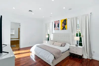 a white bedroom with a bed and a christmas tree at Luxurious 5BR and 3BA Lakefront Villa near Beach in Hollywood