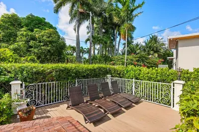 a pair of chairs sitting on a patio at Luxurious 5BR and 3BA Lakefront Villa near Beach in Hollywood