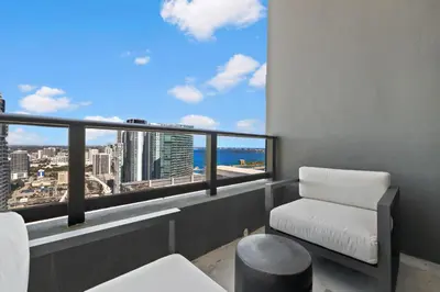 a balcony with a chair and a view of the city at 48Flr Condo w Free Parking in Miami