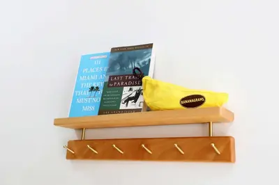 a shelf with books and a yellow purse on it at Rooftop Retreat on Ocean Drive with Beach View in Miami Beach
