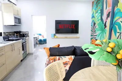 a living room with a couch and a kitchen at Rooftop Retreat on Ocean Drive with Beach View in Miami Beach