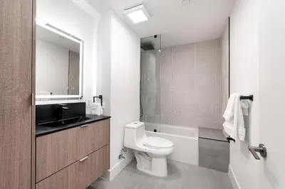 a bathroom with a toilet and a sink and a mirror at Milan Aventura Hotel in Aventura