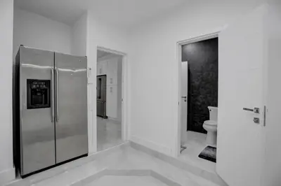 a kitchen with a stainless steel refrigerator in a room at 4 BR Designer Home Next to Shul and Community Pool villa in Fort Lauderdale
