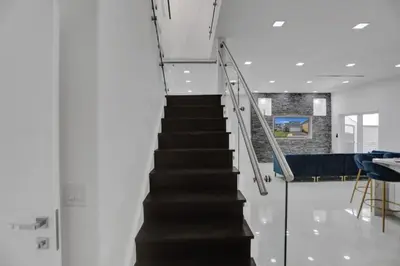 a staircase in a room with a stair case at 4 BR Designer Home Next to Shul and Community Pool villa in Fort Lauderdale