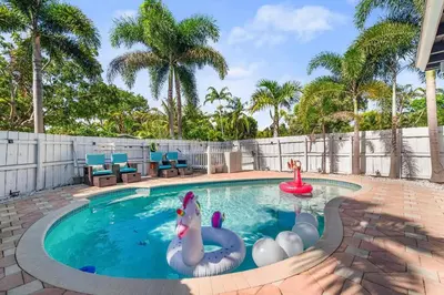 a swimming pool with two inflatable animals in it at Chic Getaway Near Wilton Drive l Your Urban Escape in Fort Lauderdale