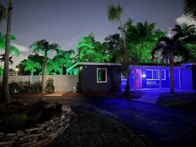a house with purple and green lights on it at Chic Getaway Near Wilton Drive l Your Urban Escape in Fort Lauderdale