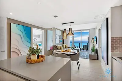 a kitchen and living room with a view of the ocean at Luxury 2BR Pools & Free Parking in Hollywood