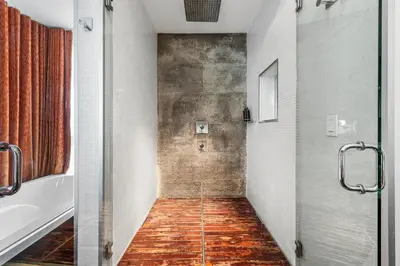 a bathroom with a shower and a tub and a toilet at Villa Nova in Miami