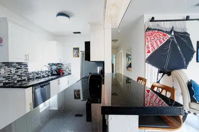 a kitchen with a counter with an umbrella on the wall at Tropical Retreat in Miami Beach in North Miami Beach