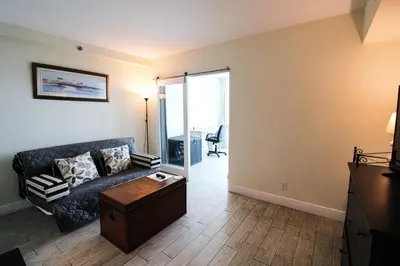 a living room with a couch and a table at Castle 929 Stunning ocean view, pool, beach access, tennis, free parking in Miami Beach