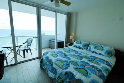 a bedroom with a bed and a view of the ocean at Castle 929 Stunning ocean view, pool, beach access, tennis, free parking in Miami Beach