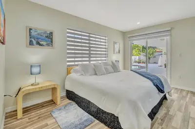 a bedroom with a large bed and a window at Dreams Studio in Hialeah