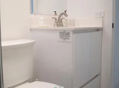 a white bathroom with a sink and a toilet at Villa Roads - Ideal Stay in Miami - King - Bed Parking - Near Airport, Brickell, Coconut Grove, Little Havana, Wynwood & Calle 8 in Miami