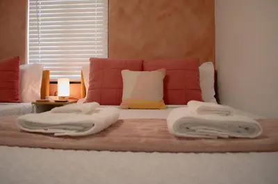 a bed with two towels on top of it at Villa Roads - Ideal Stay in Miami - King - Bed Parking - Near Airport, Brickell, Coconut Grove, Little Havana, Wynwood & Calle 8 in Miami