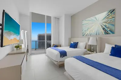 a hotel room with two beds and a balcony at 2BR Ocean View Balcony & Pool in Hollywood