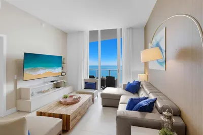 a living room with a couch and a table at 2BR Ocean View Balcony & Pool in Hollywood