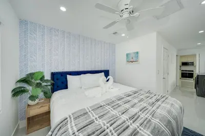 a bedroom with a bed and a ceiling fan at Home with Games Pool Paradise in Fort Lauderdale