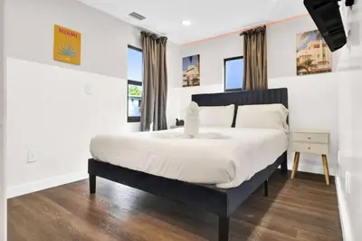 a bedroom with a large bed with white sheets at Stylish Miami Suites with Self Check-in in Miami