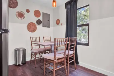 a dining room with chairs and a table and a window at Stylish Miami Suites with Self Check-in in Miami