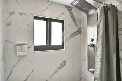 a bathroom with a shower and a window at Stylish Miami Suites with Self Check-in in Miami