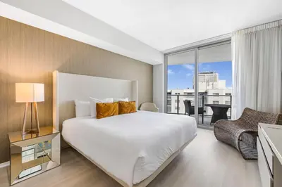 a bedroom with a white bed and a large window at Beautiful Views From a Comfortable Condo with Beach Access! in Hollywood