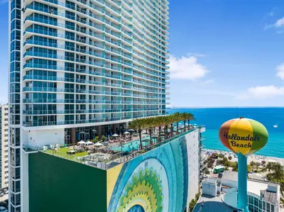 a view of a hotel with a pool and a large building at Beautiful Views From a Comfortable Condo with Beach Access! in Hollywood