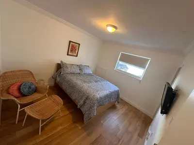 a bedroom with a bed and a table and a television at Key Biscayne Beach Vacation in Miami