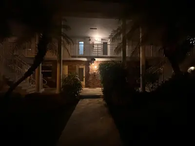 a night view of a building with palm trees at Key Biscayne Beach Vacation in Miami