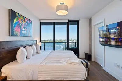 a bedroom with a large bed with a large window at Lux 2BD Apt with Stunning Water Views in Miami