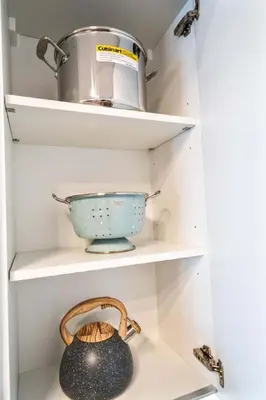 a cupboard with a bowl and a pot at Lux 2BD Apt with Stunning Water Views in Miami