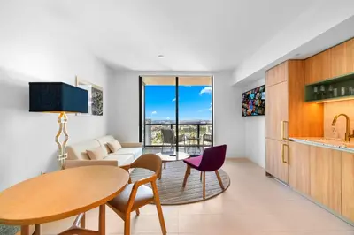 a living room with a table and chairs and a couch at Luxury Condo on 44th Floor - Downtown Plus Parking in Miami