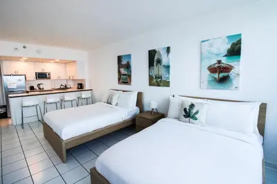 a hotel room with two beds and a kitchen at Castle 1133 Ocean view studio, Pool and Beach Access, FREE Parking, Tennis and more! in Miami Beach