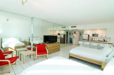 a hotel room with two beds and a living room at Castle 1133 Ocean view studio, Pool and Beach Access, FREE Parking, Tennis and more! in Miami Beach