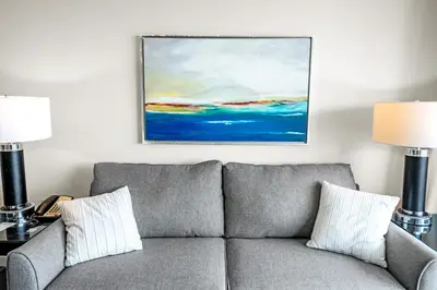 a couch in a living room with a painting on the wall at Gallery One Resort Access Fort Lauderdale Beach in Fort Lauderdale