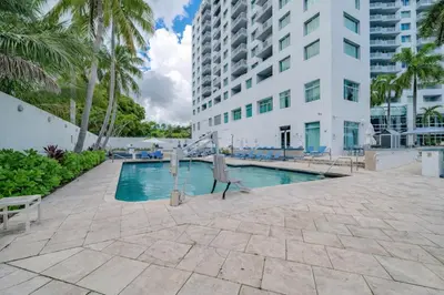 a swimming pool in front of a building at Gallery One Resort Access Fort Lauderdale Beach in Fort Lauderdale