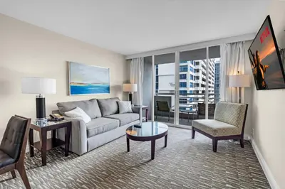 a living room with a couch and a chair at Gallery One Resort Access Fort Lauderdale Beach in Fort Lauderdale