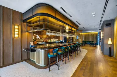 a bar with blue stools in a restaurant at PH 5107 Gale Luxury 1BR with Sea - Downtown Views in Miami