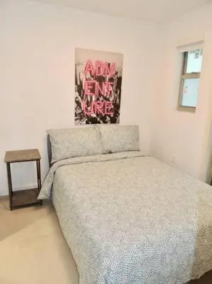 a bedroom with a bed and a picture on the wall at 2BR in Heart of SoBe with Parking in Miami Beach
