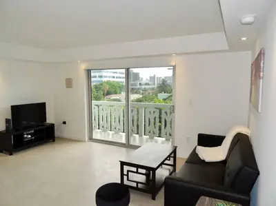 a living room with a couch and a large window at 2BR in Heart of SoBe with Parking in Miami Beach