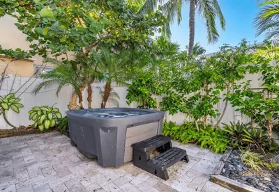 a tv sitting on a patio next to a fence at Villa Treasure on the beach by The Gold Nests in Hollywood