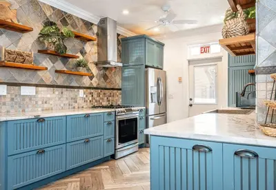 a kitchen with blue cabinets and a counter top at Villa Treasure on the beach by The Gold Nests in Hollywood