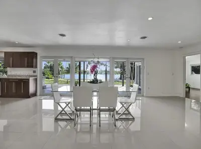 a dining room with a table and white chairs at Casa Ocaso in Miami