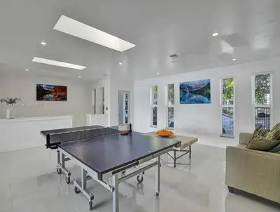 a living room with a ping pong table in it at Casa Ocaso in Miami