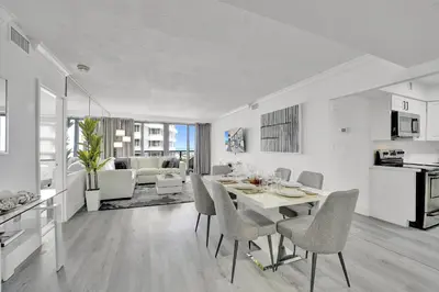 a kitchen and living room with a table and chairs at Charming Ocean View Condo Beach Service 806 in Miami Beach