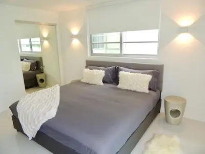 a bedroom with a bed with pillows and a window at Lux design 2 bedroom unit sleep 4 in SoBe bst area in Miami Beach