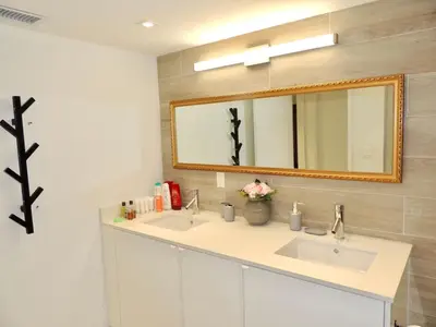 a bathroom with two sinks and a mirror at Lux design 2 bedroom unit sleep 4 in SoBe bst area in Miami Beach